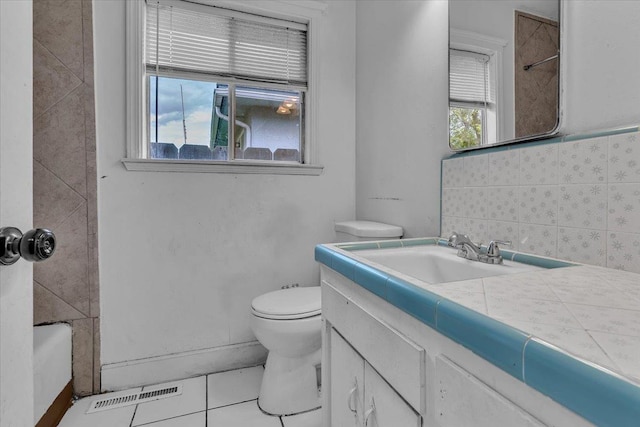 bathroom featuring vanity, visible vents, decorative backsplash, tile patterned floors, and toilet