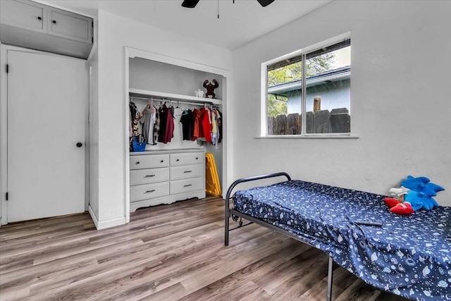 bedroom with a closet, a ceiling fan, and wood finished floors