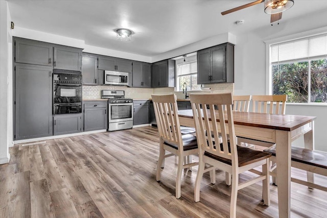 dining space featuring light wood-style flooring and a ceiling fan