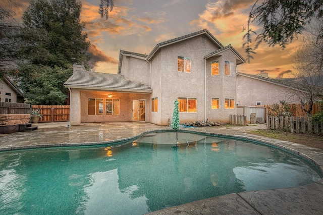 view of swimming pool featuring a patio, a fenced backyard, and a fenced in pool