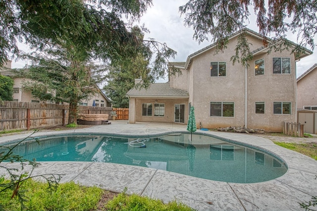 view of swimming pool featuring a patio area, a fenced in pool, a ceiling fan, and a fenced backyard