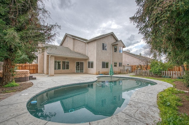 view of pool with a patio area, a fenced in pool, a hot tub, and a fenced backyard