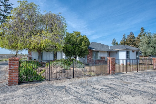 view of front facade with a fenced front yard and stucco siding