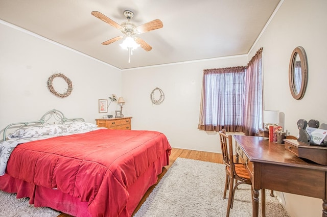 bedroom with ceiling fan, light wood-style flooring, and crown molding