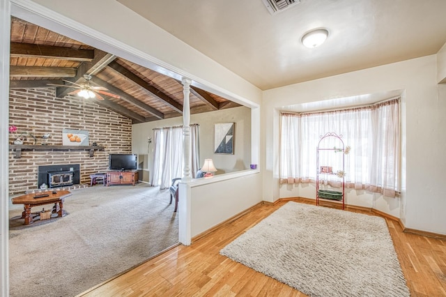 interior space featuring visible vents, ceiling fan, wood ceiling, lofted ceiling with beams, and wood finished floors