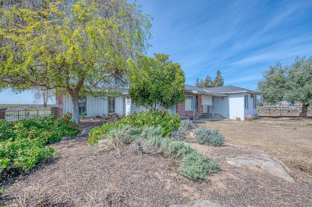 view of front of home featuring fence and stucco siding