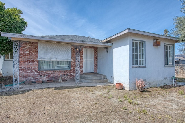 single story home with crawl space and brick siding