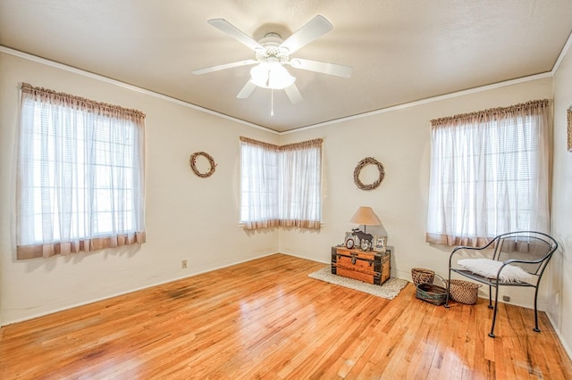 unfurnished room featuring wood finished floors, crown molding, and a ceiling fan