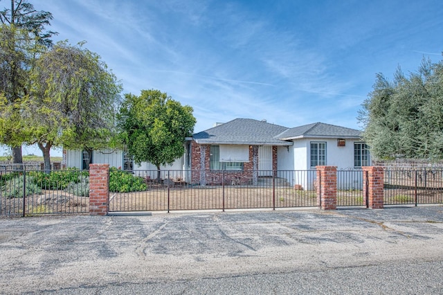 view of front of house with a fenced front yard, stucco siding, and uncovered parking