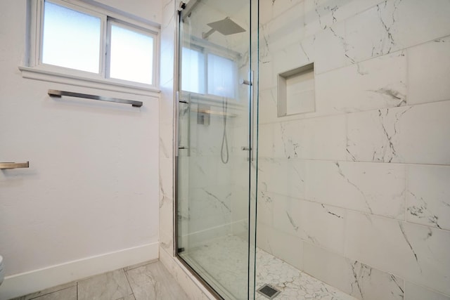 bathroom with a marble finish shower, marble finish floor, toilet, and baseboards