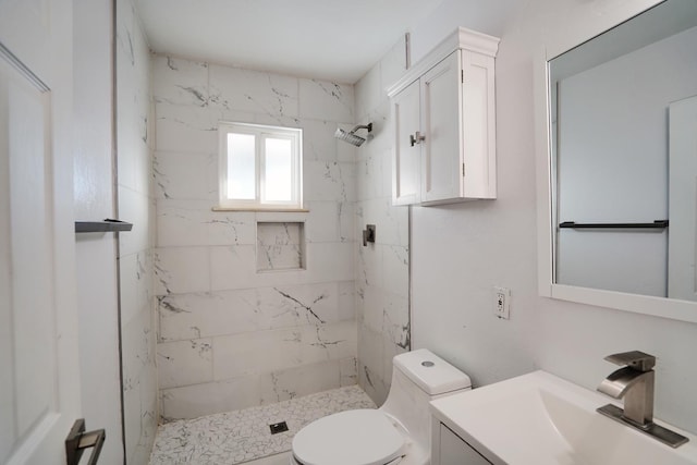 full bathroom featuring vanity, a shower stall, and toilet