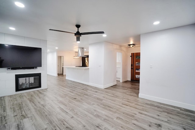 unfurnished living room with recessed lighting, baseboards, light wood-type flooring, and ceiling fan