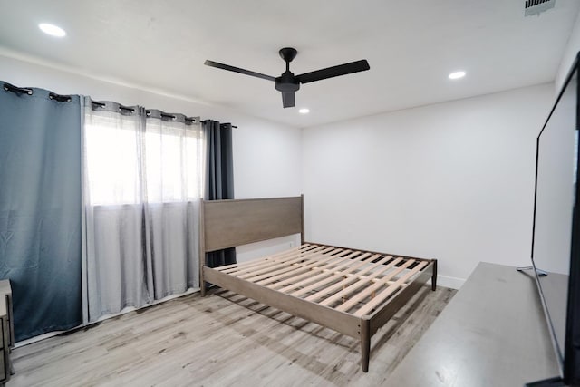 bedroom with a ceiling fan, recessed lighting, wood finished floors, and visible vents