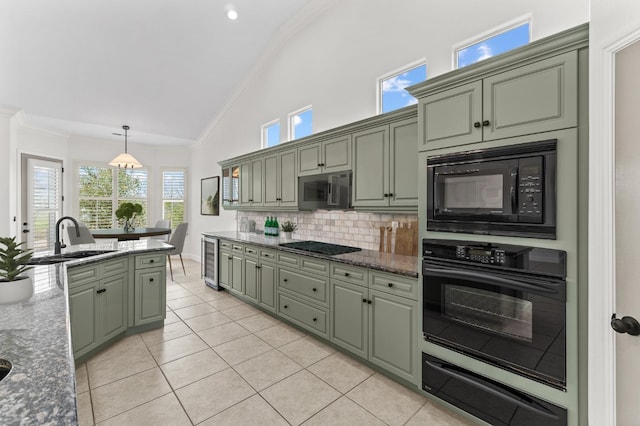 kitchen featuring wine cooler, ornamental molding, black appliances, a warming drawer, and a sink