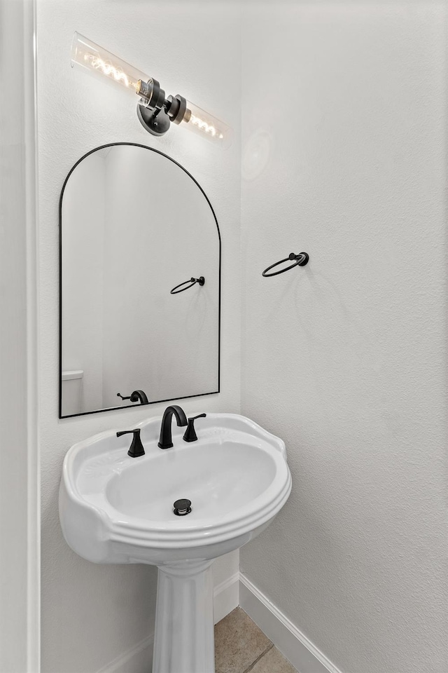 bathroom with tile patterned floors and baseboards