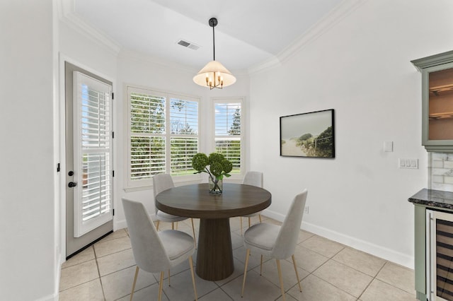 dining area with wine cooler, visible vents, light tile patterned flooring, and ornamental molding