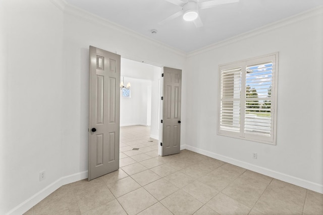 unfurnished room with ceiling fan, baseboards, and ornamental molding