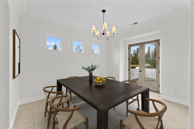 dining area featuring french doors, baseboards, a chandelier, and ornamental molding