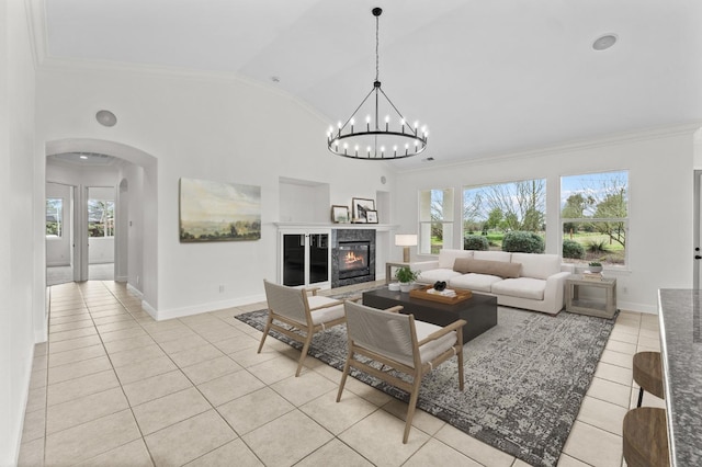 living room with light tile patterned floors, a healthy amount of sunlight, arched walkways, and crown molding