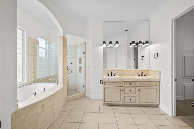 full bathroom featuring a garden tub, a stall shower, ornamental molding, a sink, and tile patterned floors