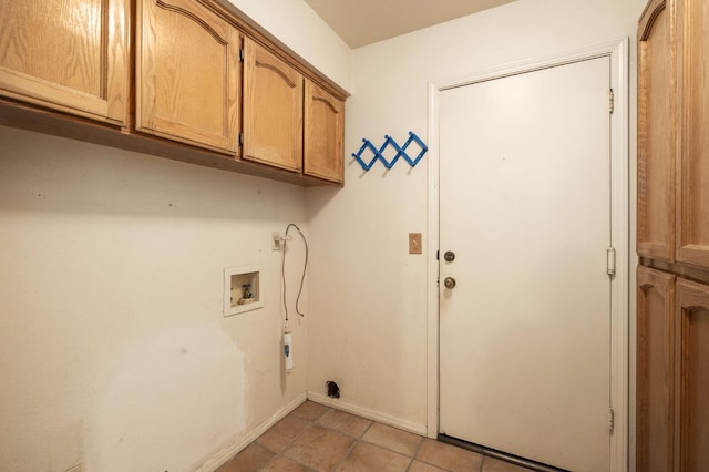 clothes washing area with hookup for a washing machine, cabinet space, and baseboards