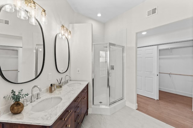 bathroom with a sink, visible vents, and a stall shower