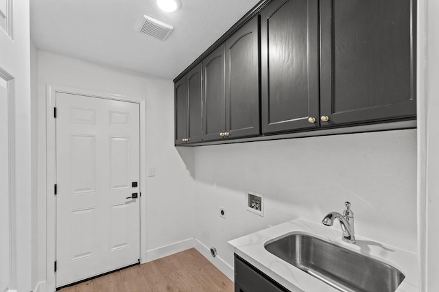 laundry area featuring hookup for a washing machine, visible vents, cabinet space, electric dryer hookup, and a sink