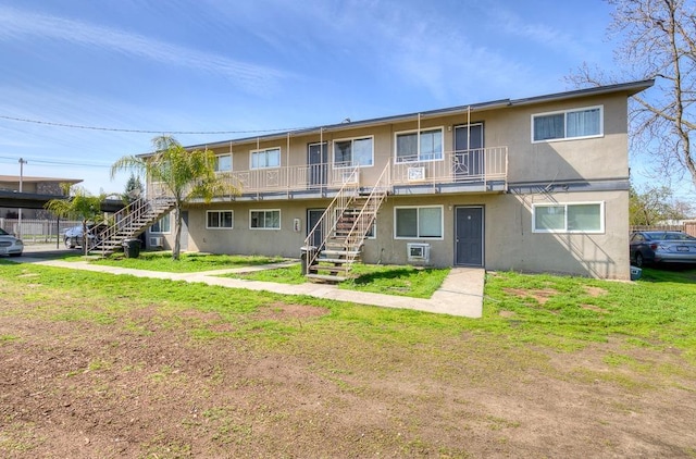 4421 E Hedges Ave, Fresno, CA 93703 - exterior space with stairway, stucco siding, and a yard