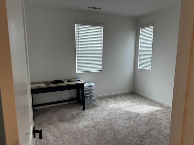 office area with carpet flooring, visible vents, and baseboards