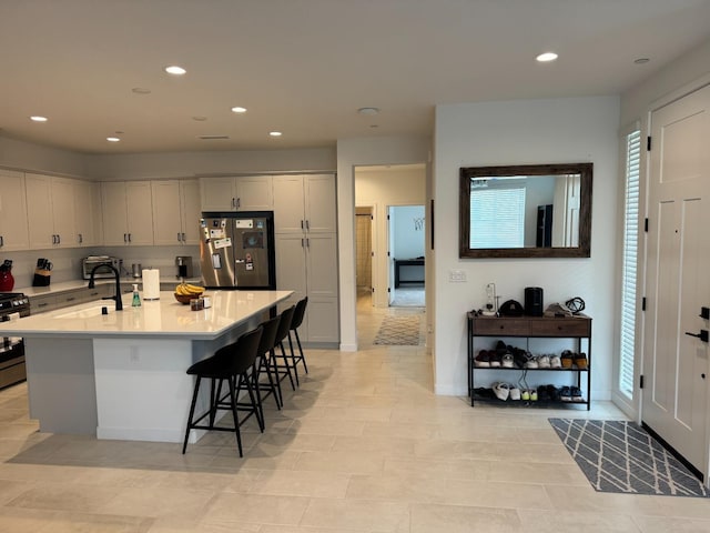 kitchen with light countertops, recessed lighting, appliances with stainless steel finishes, and a sink