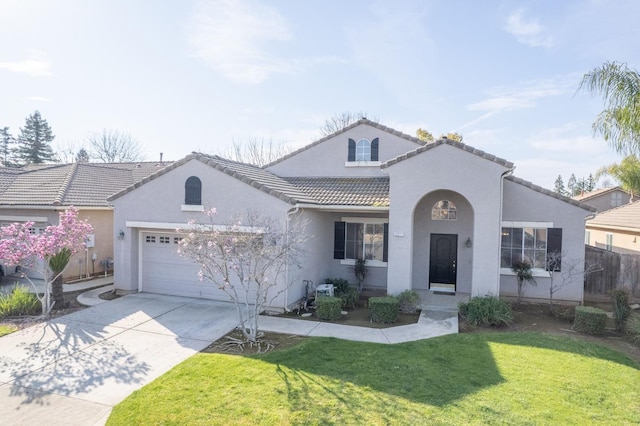 mediterranean / spanish-style home with driveway, stucco siding, a front lawn, a garage, and a tiled roof