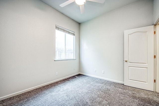 unfurnished room featuring carpet flooring, a ceiling fan, and baseboards