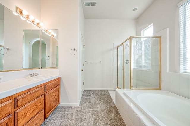 full bath with visible vents, a garden tub, a shower stall, baseboards, and vanity