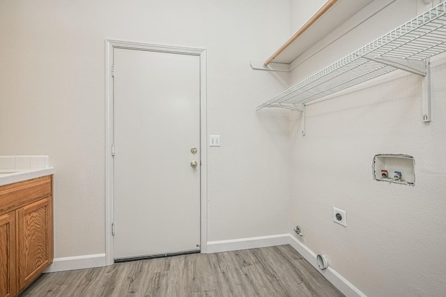 laundry area featuring baseboards, laundry area, electric dryer hookup, washer hookup, and light wood-style floors