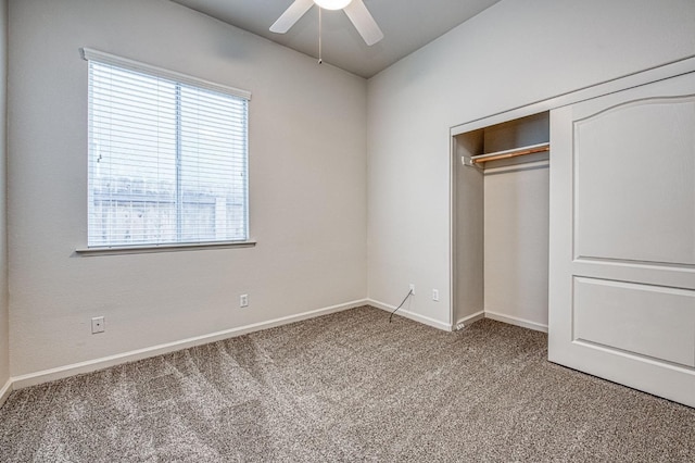 unfurnished bedroom featuring a closet, a ceiling fan, baseboards, and carpet floors