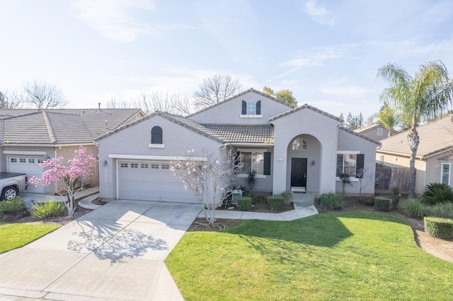 mediterranean / spanish-style house with stucco siding, concrete driveway, a front yard, a garage, and a tiled roof