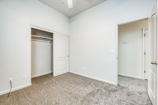 unfurnished bedroom featuring a closet, baseboards, a ceiling fan, and carpet flooring