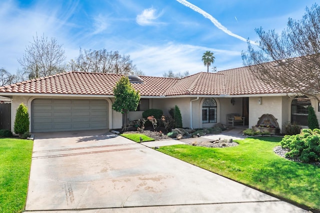 view of front of home with stucco siding, driveway, a front lawn, and a tile roof