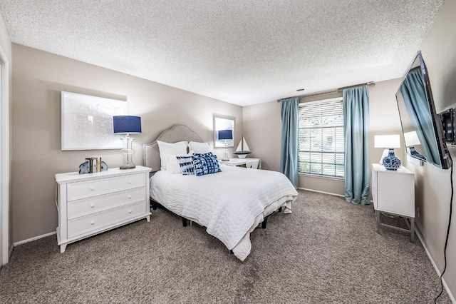 bedroom with baseboards, carpet floors, and a textured ceiling