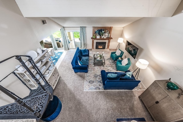 living room featuring visible vents, carpet flooring, and a fireplace