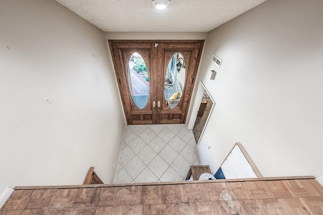 foyer with a textured ceiling