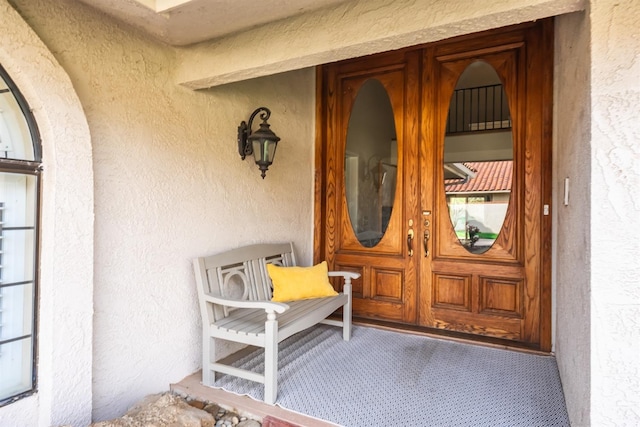 doorway to property with stucco siding