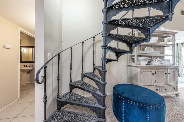 stairway featuring tile patterned flooring and baseboards