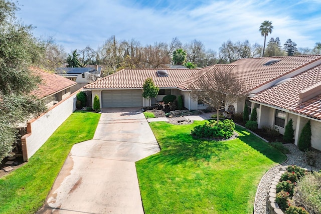 mediterranean / spanish-style home featuring stucco siding, a tiled roof, driveway, and a front yard