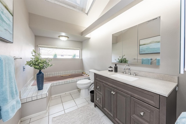 full bathroom featuring tile patterned flooring, toilet, vanity, and a garden tub