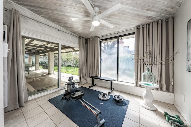 workout area featuring light tile patterned floors, wooden ceiling, and a ceiling fan