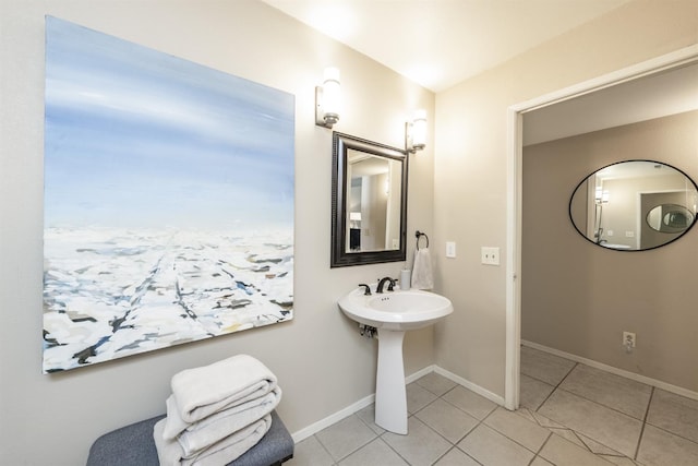 bathroom with tile patterned floors, baseboards, and a sink