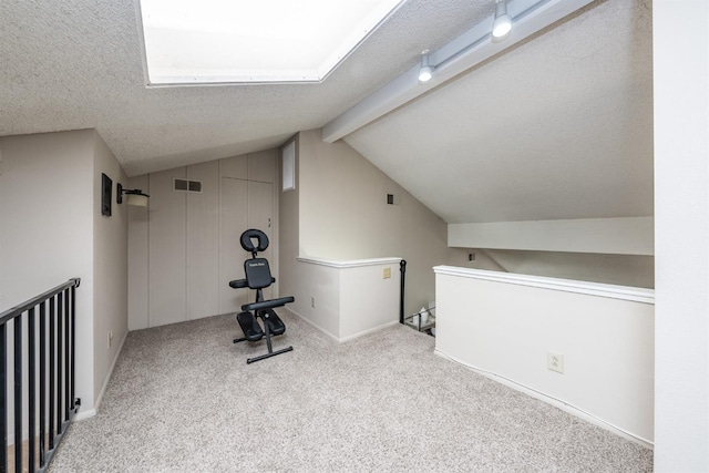 exercise area featuring visible vents, lofted ceiling, a textured ceiling, and carpet