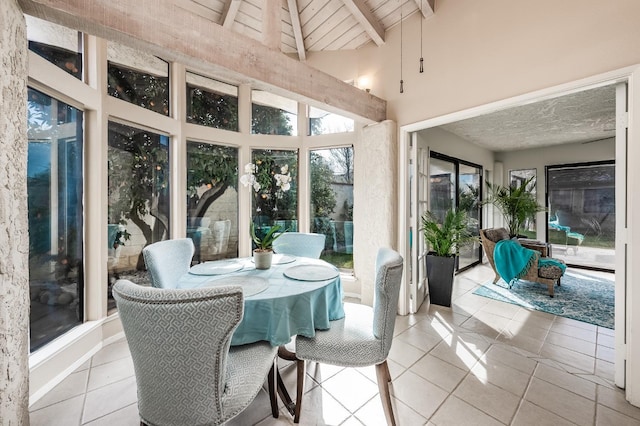 sunroom featuring wood ceiling and lofted ceiling with beams