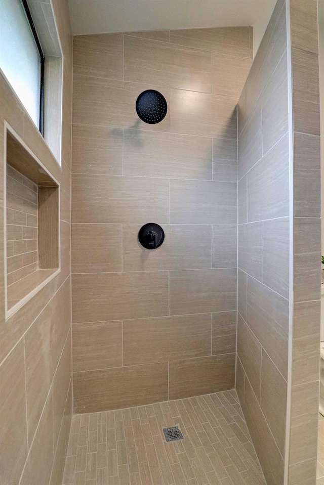 full bath with a tile shower